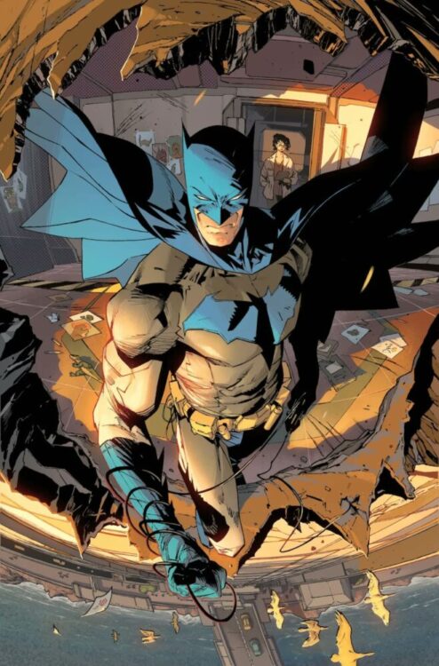 Batman stands in a broken wall, facing the city.